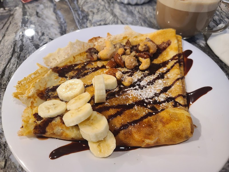 Banana chocolate crepe and latte on the counter at Vera Cafe